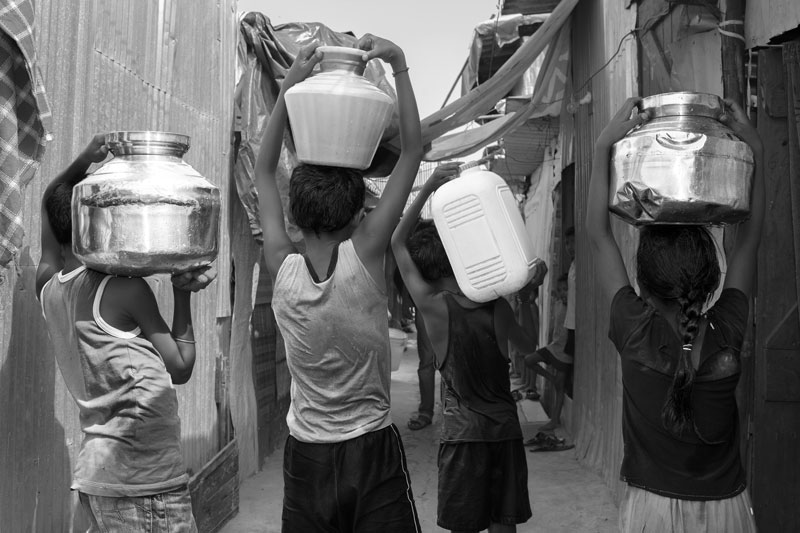 Human Right to Water in Mumbai - Children hauling loads of water compromising their valuable study or play time